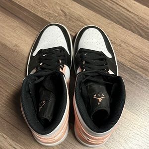 pink, white, and black jordan 1’s